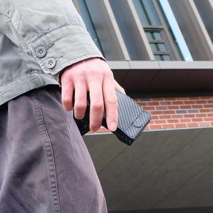 Fanning Wallet being held in hand outside of a building in Australia